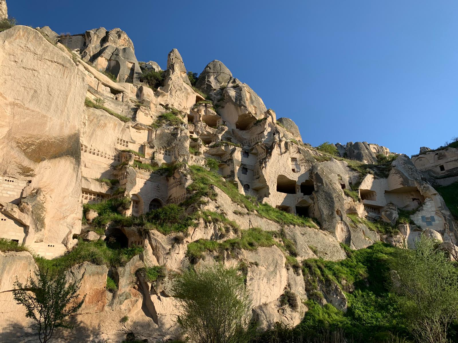 Rock-cut cave dwellings on a Cappadocia cliff face near Aya Kapadokya